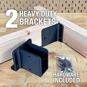 May include: Two heavy-duty black metal brackets with included hardware, displayed with wooden beams. The image includes the text "2 HEAVY DUTY BRACKETS" and "HARDWARE INCLUDED".