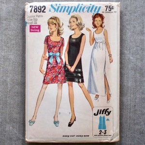 May include: Vintage Simplicity sewing pattern number 7892 for a Junior Petite size 5jp bust 31. The pattern includes three dress styles: a floral print dress with short sleeves and a bow, a black sleeveless dress with a contrasting black and white trim, and a white sleeveless maxi dress with a side slit.