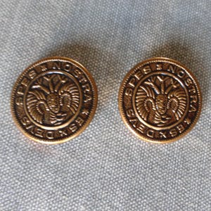 May include: Two gold-colored metal buttons with the words "Spes Nostra" and a stylized bird design.