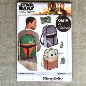 May include: A Simplicity home sewing pattern for backpacks and accessories, featuring designs inspired by Star Wars: The Book of Boba Fett. The pattern includes designs for backpacks with a Boba Fett theme, a grey backpack, and a Baby Yoda backpack.