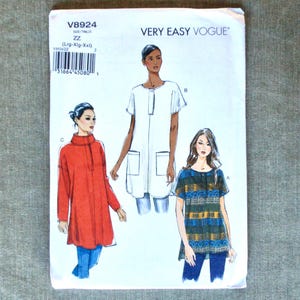 May include: A Very Easy Vogue sewing pattern, V8924, featuring illustrations of three different tunic tops. The pattern includes sizes Lrg-Xlg-XXL. The cover is white with the Very Easy Vogue logo and product details.