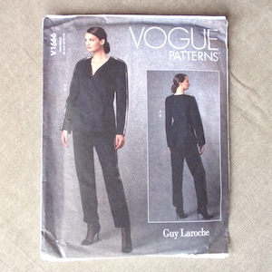 May include: A Vogue Patterns sewing pattern envelope, V1666, featuring a Guy Laroche design for a black wrap-style jacket and matching trousers. The cover displays a front and back view of the garment on a model, with the text Vogue Patterns and Guy Laroche clearly visible on the white and grey packaging.