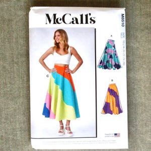 Puede incluir: Patrón de costura McCall's M8510. El patrón presenta a una mujer con una falda colorida y fluida. El diseño de la falda incluye secciones en naranja, azul, rosa y amarillo. El patrón también muestra otros dos diseños de falda. Diseñado e impreso en EE. UU.