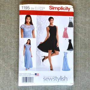 May include: A Simplicity sewing pattern package featuring images of various formal dresses. The package has a red and white header with the brand name. The package includes images of a blue lace dress and a black lace dress.