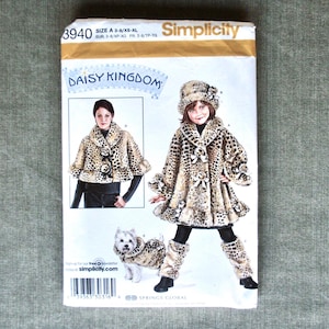 May include: Simplicity sewing pattern 3940 for a child's coat, hat, and leggings. The pattern features a leopard print design. The package includes illustrations of the finished garments and a small dog in matching attire. The text "DAISY KINGDOM" is visible.