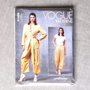 May include: A Vogue Patterns sewing pattern envelope, R10458, featuring a yellow blazer and matching wide-leg trousers. The cover displays two images of the garment, one with a blazer and one with a white t-shirt, with the text Vogue Patterns.