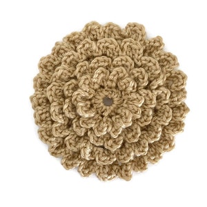 May include: A handmade, crocheted flower in a light tan color. The flower is circular with multiple layers of petals, creating a textured, three-dimensional effect. The center of the flower has a small, open hole. The craft item is set against a white background.