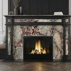 May include: A fireplace with a black frame and a marble-like patterned surround. The fireplace has a fire burning inside. The mantel is made of wood. There are two windows on either side of the fireplace.