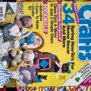 May include: A magazine cover titled "Crafts" with a yellow background and various craft projects. The cover features the text "34 Spring How-To's For Home Decor And More" and images of stuffed animals and other craft items.