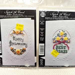 May include: Two "Stitch A Card" kits with embossed cards. One says "Happy Anniversary" with yellow roses, the other says "Best Wishes" with a floral bouquet. Each kit includes ribbon, needle, and instructions.