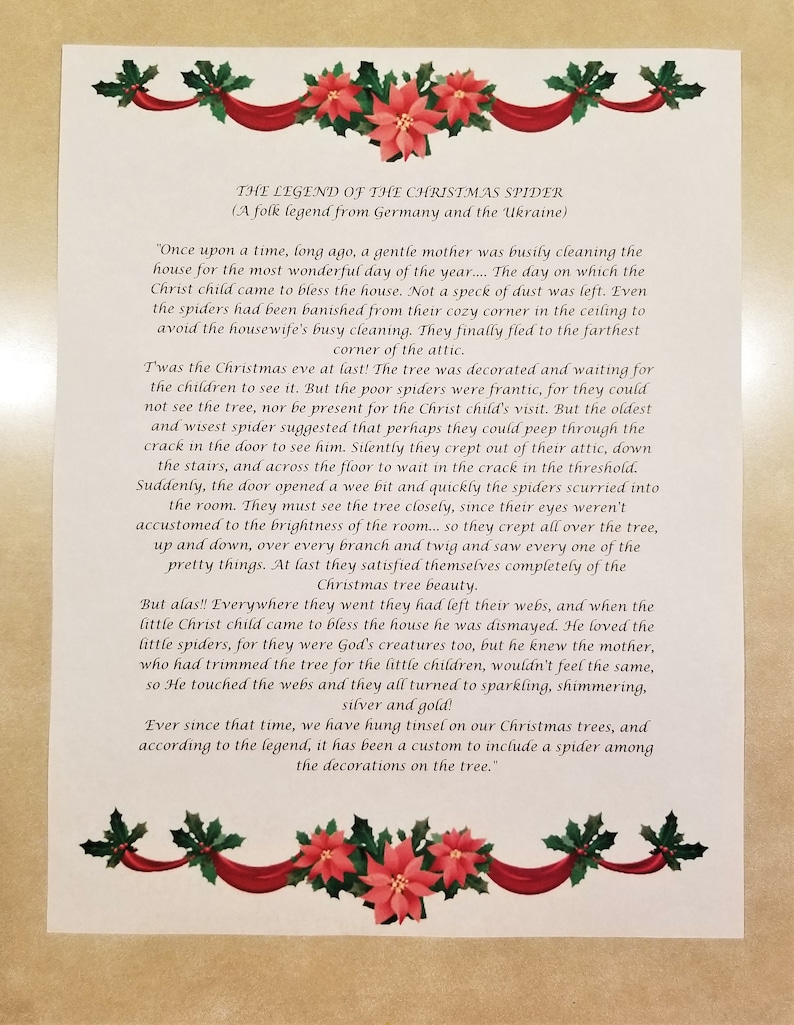 May include: A printed page with the text "THE LEGEND OF THE CHRISTMAS SPIDER" and a folk tale about spiders and Christmas trees. The text is surrounded by a decorative border of red ribbons, green holly, and red poinsettias.