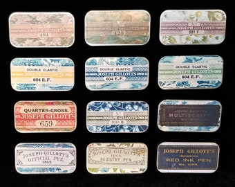 May include: Twelve vintage tin boxes with different designs and text. The boxes are all rectangular and have a white background. The text on the boxes includes the name "Joseph Gillott's" and various numbers. The boxes are arranged in three rows of four.
