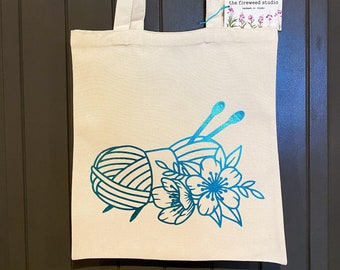 Holographic design yarn skeins with knitting needles and flowers tote bag