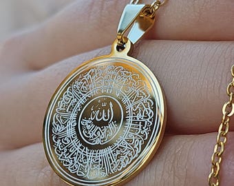 Può includere: Collana d'oro con un ciondolo rotondo che presenta intricata calligrafia araba bianca, inclusa la parola "Allah" al centro.
