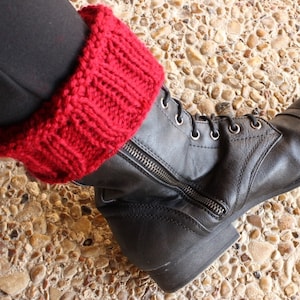 May include: Black leather ankle boots with a red knitted cuff. The boots have a zipper on the side and laces up the front.