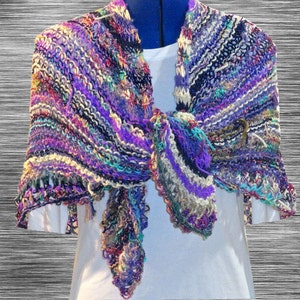 May include: A multi-colored knitted shawl with a fringed edge. The shawl is made with a variety of yarns in shades of purple, blue, green, and white.