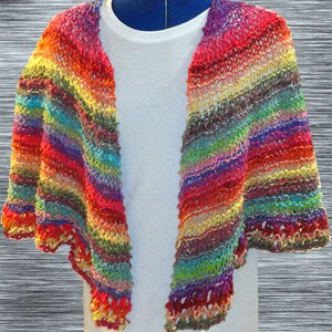 May include: A colorful striped knitted shawl with a scalloped edge. The shawl is made with a variety of colors, including red, orange, yellow, green, blue, purple, and brown.