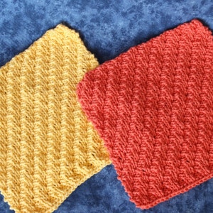 May include: Two knitted dishcloths, one yellow and one orange, with a textured pattern.