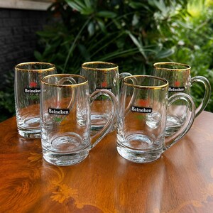 Rare Heineken breweriana glasses featuring classic brewery emblem