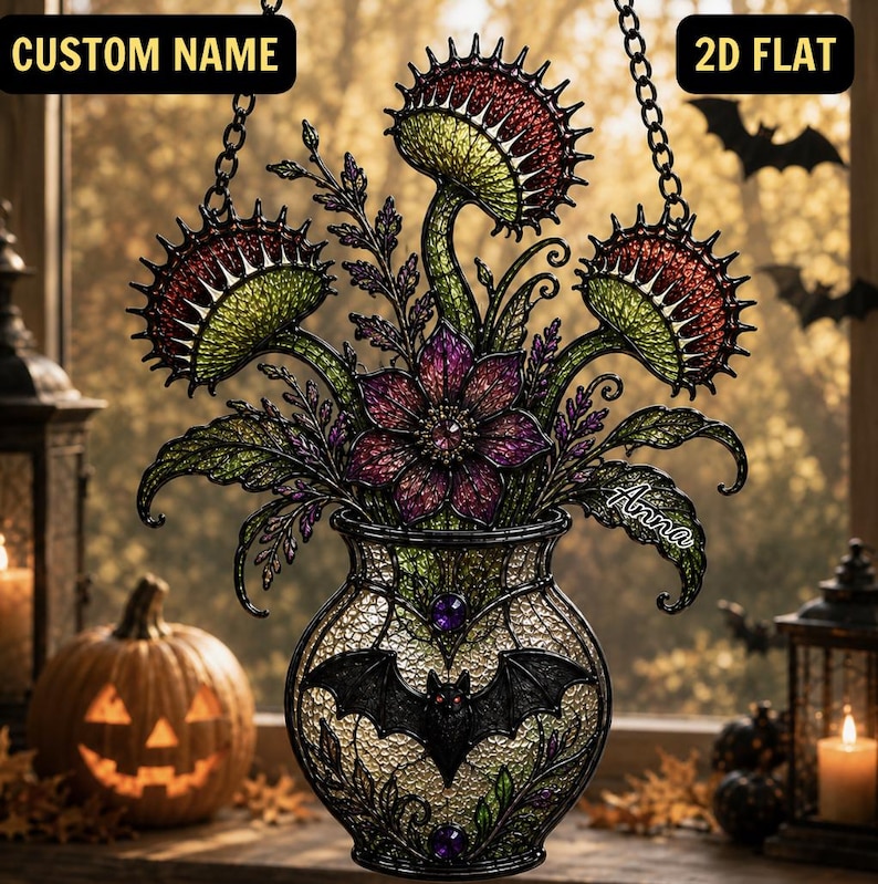 May include: A hanging stained glass-style ornament featuring three green and red Venus flytraps and a central purple flower in a vase decorated with a black bat and purple gems. The text CUSTOM NAME and 2D FLAT appear at the top, with Anna written on the side.
