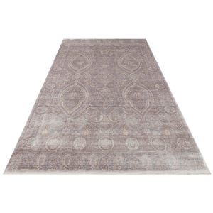 May include: A rectangular area rug featuring a muted mauve and taupe color palette with an intricate, symmetrical pattern of ornate medallions, scrolling floral motifs, and a detailed border design that spans the entire surface of the floor covering.
