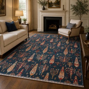 May include: A rectangular area rug featuring a deep blue background with a repeating pattern of stylized trees in shades of red, orange, yellow, and cream. The rug has a short fringe along the edges and a dense, intricate botanical design.