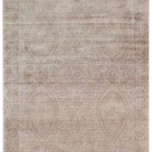 May include: A rectangular area rug featuring a faded, distressed beige and taupe color palette. The design displays an intricate, symmetrical pattern of large central medallions surrounded by ornate floral and paisley motifs throughout the surface.