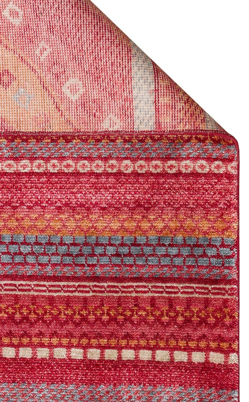 May include: A rectangular area rug featuring a vibrant red base color with horizontal bands of intricate geometric patterns in shades of orange, light blue, and cream. The rug has a textured pile surface and a folded corner revealing the underside.
