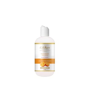 May include: A white bottle of Skin Key Citrus Moisturizing Face Wash with Honey. The bottle is labeled with the product name and ingredients. The bottle is 6 oz and has a white cap. The bottle is sitting on a white background. The bottle has a picture of two orange slices on the front.