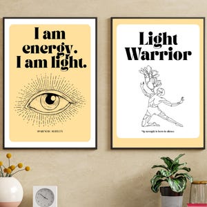 May include: Two framed art prints with inspirational quotes. One features the text "I am energy. I am light." above an eye illustration. The other says "Light Warrior" with a line drawing of a person holding flowers.