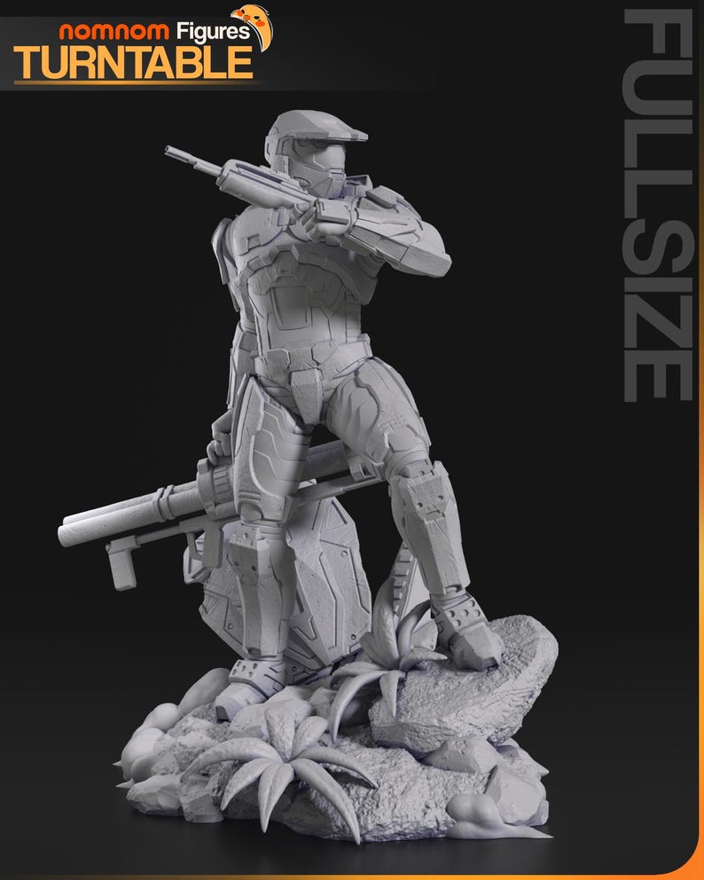 May include: A gray 3D printed figurine of a Master Chief character from the Halo video game series. The character is holding a weapon and is standing on a rocky base with plants. The text 'nomnom Figures TURNTABLE FULLSIZE' is visible in the background.
