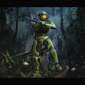 May include: A detailed action figure of a character in green and black armor, holding a rifle, set against a jungle backdrop. The figure has a helmet with an orange visor. The "Nom Nom Figures" logo is in the lower left corner.