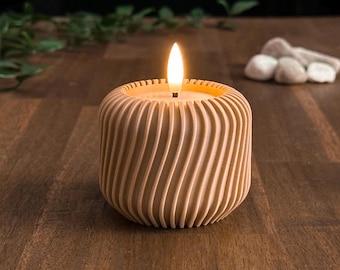 May include: A lit wooden candle with a swirling, grooved design. The candle has a warm, inviting glow, and the wood has a natural, light brown color. The candle is on a dark wooden surface.