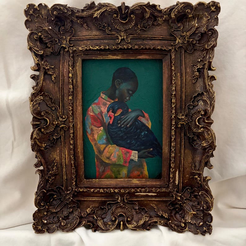 May include: An oil painting in a dark brown ornate frame featuring a person wearing a colorful patterned shirt holding a large black bird against a deep green background. The frame has intricate carved details with gold-toned highlights throughout.