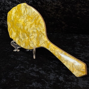 May include: A set of three ceramic mugs with a speckled, matte finish. The mugs are in shades of cream, light gray, and dark gray. Each mug has a simple, minimalist design, perfect for coffee or tea.