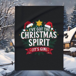 May include: Black graphic tee with the text "I've Got The Christmas Spirit (It's Gin)". The design includes Santa hats, a gold star, and festive green accents. A fun, holiday-themed shirt.