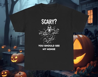 May include: Black t-shirt featuring a white ghost design and the text "SCARY? YOU SHOULD SEE MY MINGE". The image has a Halloween theme, with pumpkins and a haunted house in the background.