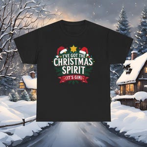 May include: Black t-shirt with a Christmas-themed graphic. The design includes the text "I've Got The Christmas Spirit (It's Gin)" in white, green, and red, with Santa hats and a star.