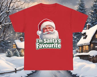May include: Red t-shirt featuring a winking Santa Claus graphic with the text "I'm Santa's Favourite" in white and green. The design is centered on the front of the shirt, perfect for the holiday season.