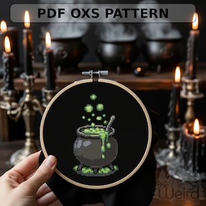 May include: A cross-stitch embroidery hoop featuring a pixelated cauldron with green bubbling potion. The text "PDF OXS PATTERN" is at the top. The background includes lit candles and cauldrons, creating a spooky theme.
