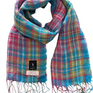 May include: A colorful plaid scarf in shades of turquoise, pink, and yellow. The scarf has a fringed edge and a label with the brand name "CODELO". The scarf is made of a lightweight material, perfect for adding a pop of color to any outfit.
