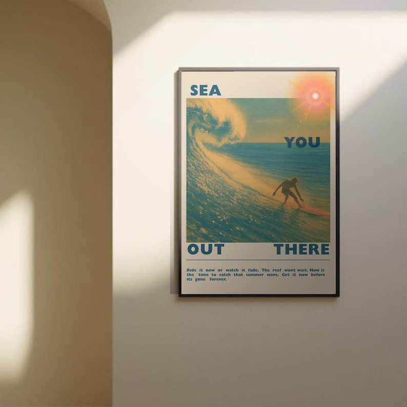 May include: A framed poster with a vintage surf theme. The poster features a surfer riding a wave, with the words "SEA YOU OUT THERE" in large letters. The poster has a retro color palette of blues, yellows, and oranges.