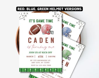 May include: A printable invitation for a 1st birthday party with a football theme. The invitation features a football and helmet in red, blue, and green. The text on the invitation reads "It's Game Time" and "Caden is turning one".