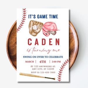May include: Baseball-themed birthday party invitation with red, white, and blue colors. It says "It's Game Time" and "Caden is turning one". The invitation includes a baseball glove, baseball, and baseball helmet.