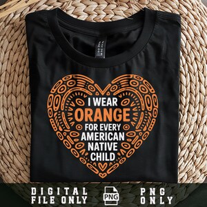 May include: Black t-shirt with an orange heart-shaped design. The design includes the text "I WEAR ORANGE FOR EVERY AMERICAN NATIVE CHILD." The shirt is folded on a woven surface. The bottom of the shirt has the text "DIGITAL FILE ONLY PNG ONLY."