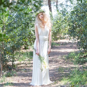 The model is wearing a long infinity dress as a wedding dress. It looks simple, but elegant and rustic.