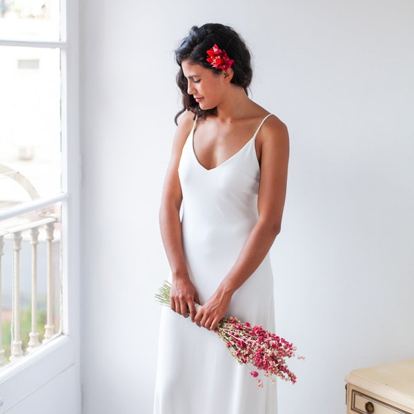 Simple and elegant slip wedding dress with thin spaghetti straps and low cut back