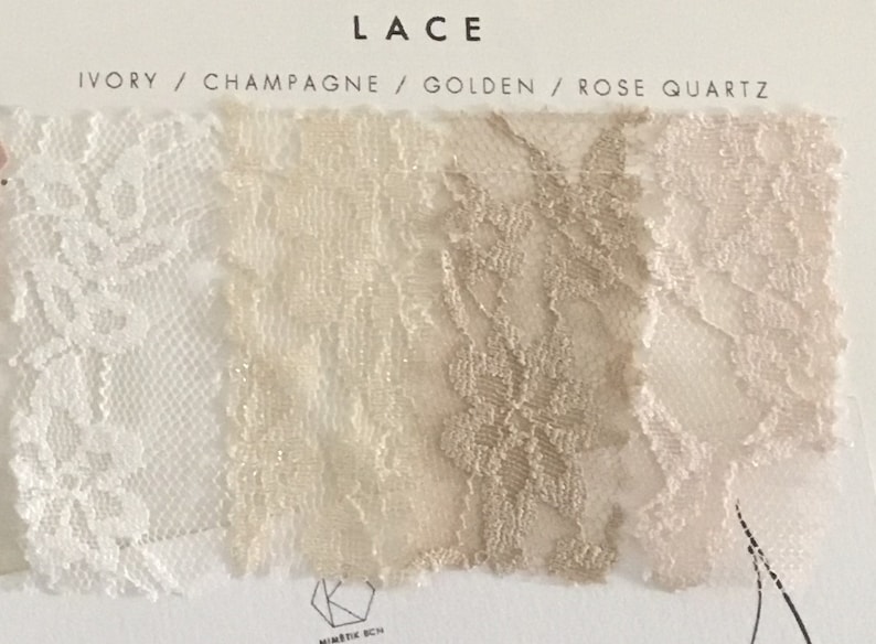 May include: A fabric swatch card labeled LACE with four color options: Ivory, Champagne, Golden, and Rose Quartz. Each section displays a distinct floral lace pattern in its respective color, arranged horizontally on a white background.