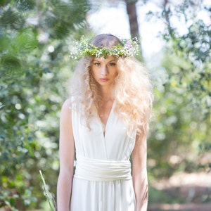 The model is in the woods with her bridal gown. She has wrapped it with deep v-neck, which is one of the ways to wear it,