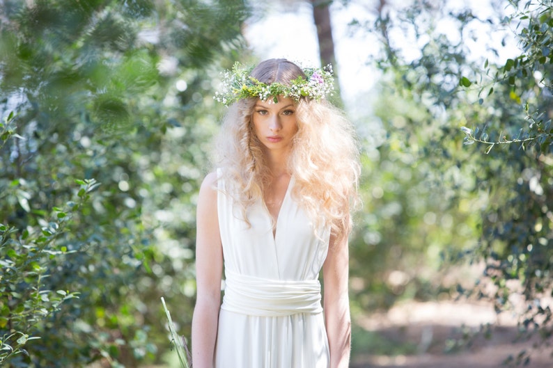 The model is in the woods with her bridal gown. She has wrapped it with deep v-neck, which is one of the ways to wear it,